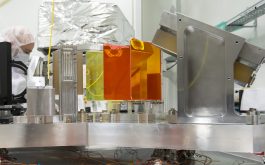 2016/12 - R2 échelle grating (right) and triple-prism cross-disperser (middle, the orange and yellow prisms are made of ZnSe and Infrasil respectively) in their dedicated mounts (©S.Chastanet – CNRS/OMP)